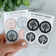 These sticker sheets contain 4 St Benedict medal stickers. One sheet has colored medals, with tan, blue, navy, and pink. The other sheet is black and white. They are dishwasher safe and weatherproof mini vinyl stickers. 