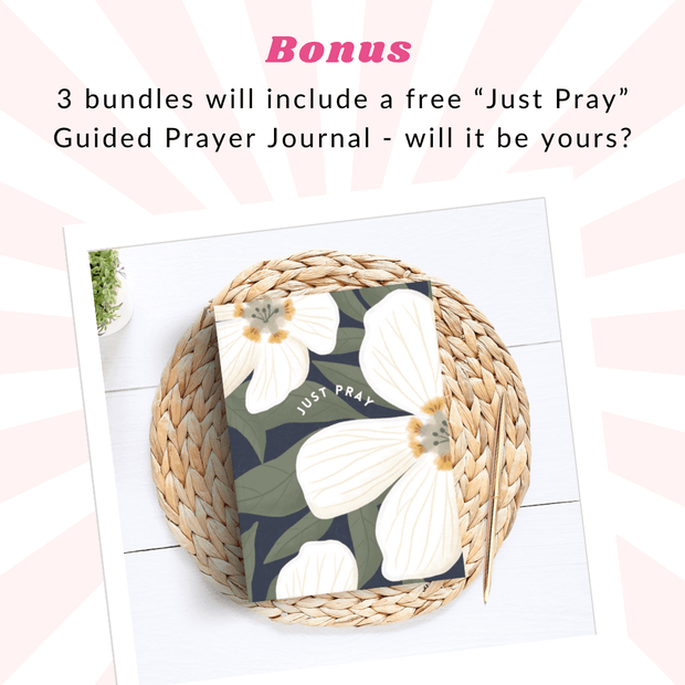 An image promoting a bonus for the "St. Valentine's Day Mystery Bundle." The text at the top reads: "Bonus: 3 bundles will include a free 'Just Pray' Guided Prayer Journal – will it be yours?" Below is a photo of the "Just Pray" journal, featuring a floral design with white flowers and green leaves, displayed on a round woven placemat atop a white wooden surface. The background has a soft pink and white radiating stripe design.