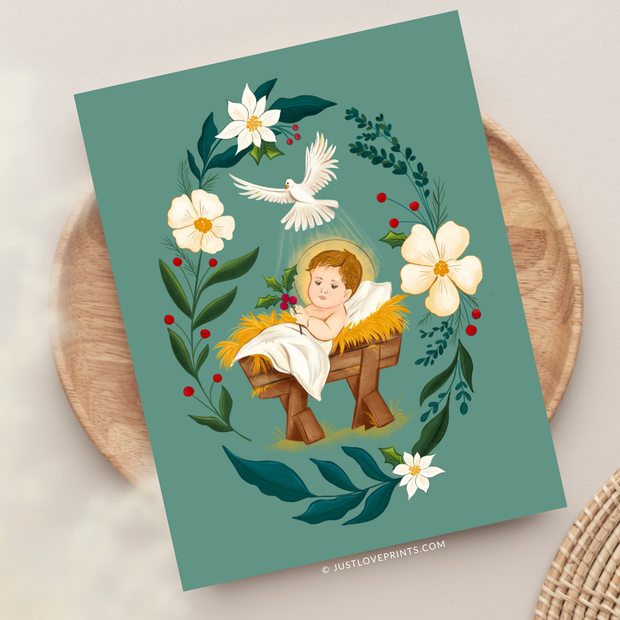 Christmas card with Baby Jesus in a manger surrounded by florals and holly, holding a sprig of holly in His hand.