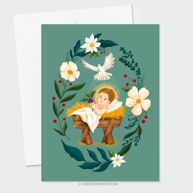 Christmas card with Baby Jesus in a manger surrounded by florals and holly, holding a sprig of holly in His hand.