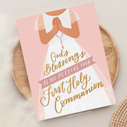 A card for a girl's first holy communion celebration, featuring religious symbols and elegant typography.