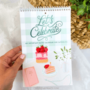 Calendar titled 'Let's Celebrate' held by a hand with a decorative background.