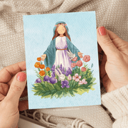 Illustration of the Virgin Mary with closed eyes, standing in a garden surrounded by colorful flowers and a small rabbit, wearing a dress and a floral crown.