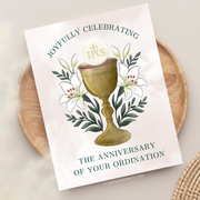 Greeting card with golden chalice, white lilies, and the words “Joyfully celebrating the anniversary of your ordination.”