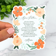 Floral vinyl sticker with the full text of the Our Father prayer framed by orange flowers.