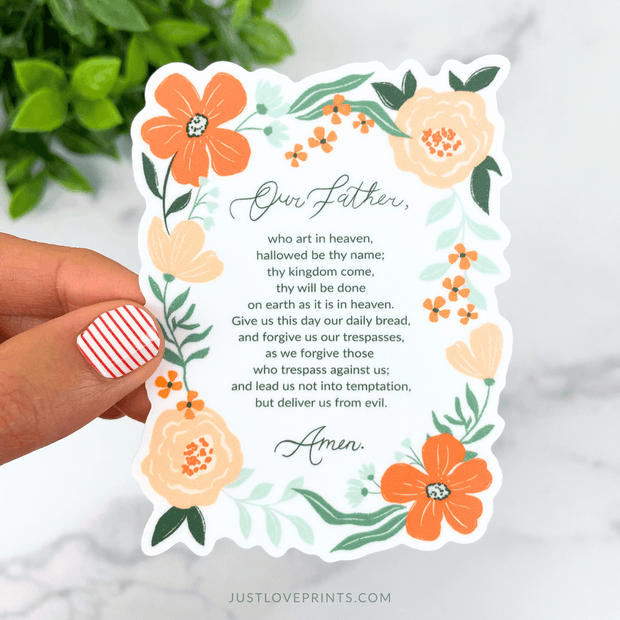 Floral vinyl sticker with the full text of the Our Father prayer framed by orange flowers.