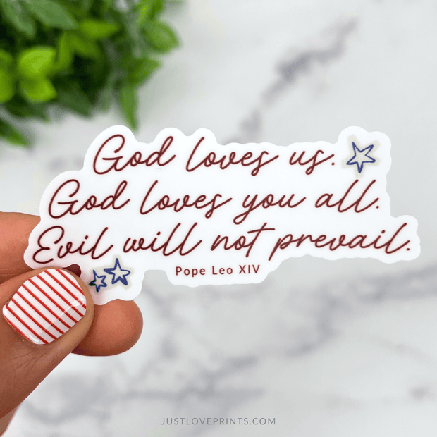 Vinyl sticker with the quote “God loves us. God loves you all. Evil will not prevail.” from Pope Leo XIV in red lettering with blue stars.