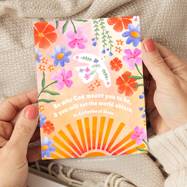 Greeting card with colorful flowers, sun rays, and quote from St. Catherine of Siena: “Be who God meant you to be, and you will set the world ablaze.”