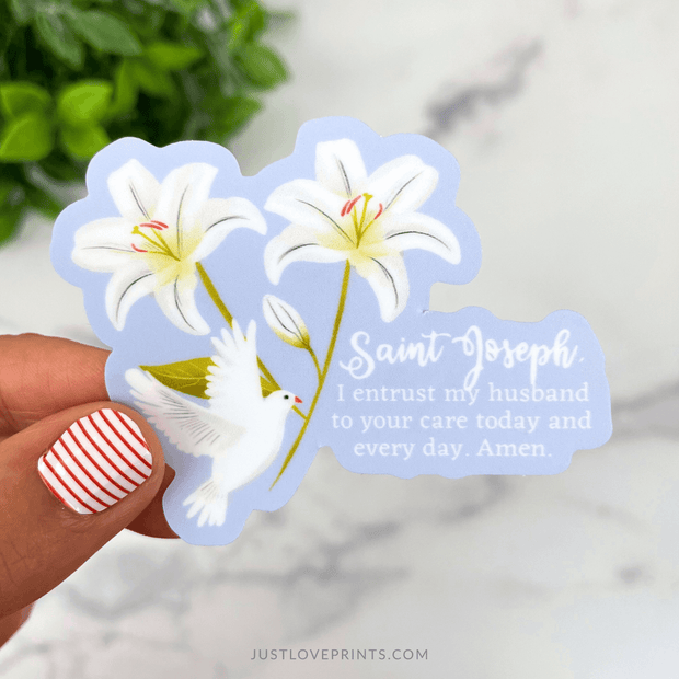 Sticker featuring lilies and a white dove with the prayer “St. Joseph, I entrust my husband to your care today and every day.”