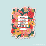 Floral sticker featuring the Bible verse:
"We love because He first loved us." – 1 John 4:19.