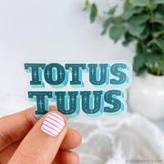 "TOTUS TUUS" in all capitals and in blue block letters. 