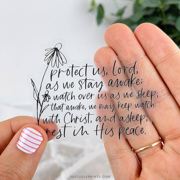 Clear sticker with black text and a flower that reads: "Protect us, Lord, as we stay awake; watch over us as we sleep, that awake, we may keep watch with Christ, and asleep, rest in his peace."